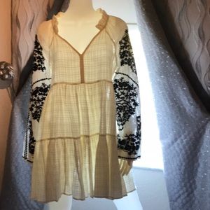 Cream babydoll dress with black embroidered sleeves by Free People